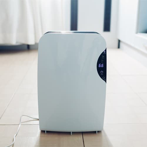 A dehumidifier is a device that draws moisture out of the air. A fan in the dehumidifier pulls air from the surrounding area into the unit.