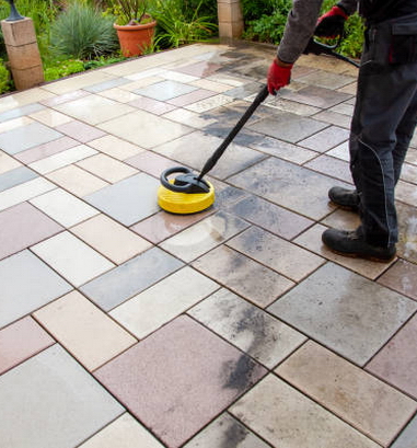 Person worker cleaning the outdoors floor.