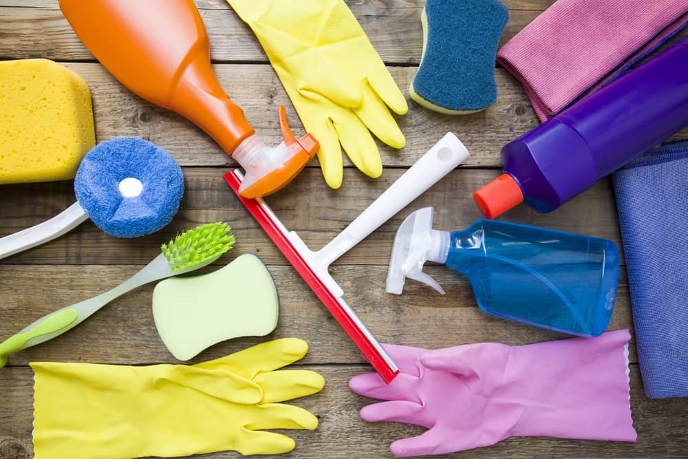 Brushes, rubber gloves, and cleaning supplies to clean a home for the holidays