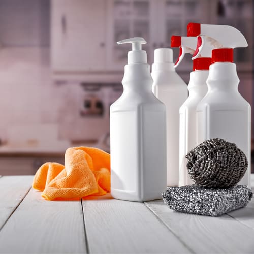 Brushes, rubber gloves, and cleaning supplies to clean a home for the holidays