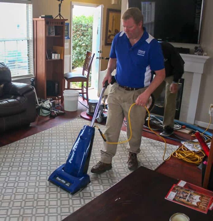 Matt Lashway, owner of Whitehall Carpet Cleaners, cleaning an area rug