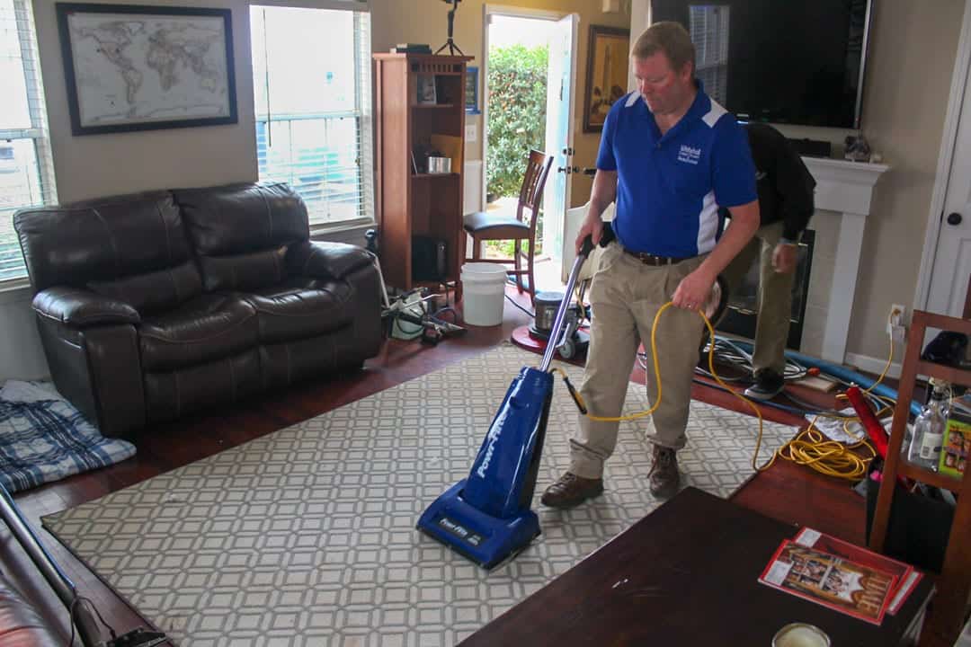 Matt Lashway, owner of Whitehall Carpet Cleaners, cleaning an area rug